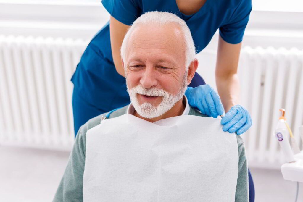 dentist-getting-senior-patient-ready-fora dental checkup